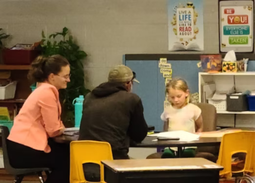 Parents being led by their student in a conference 